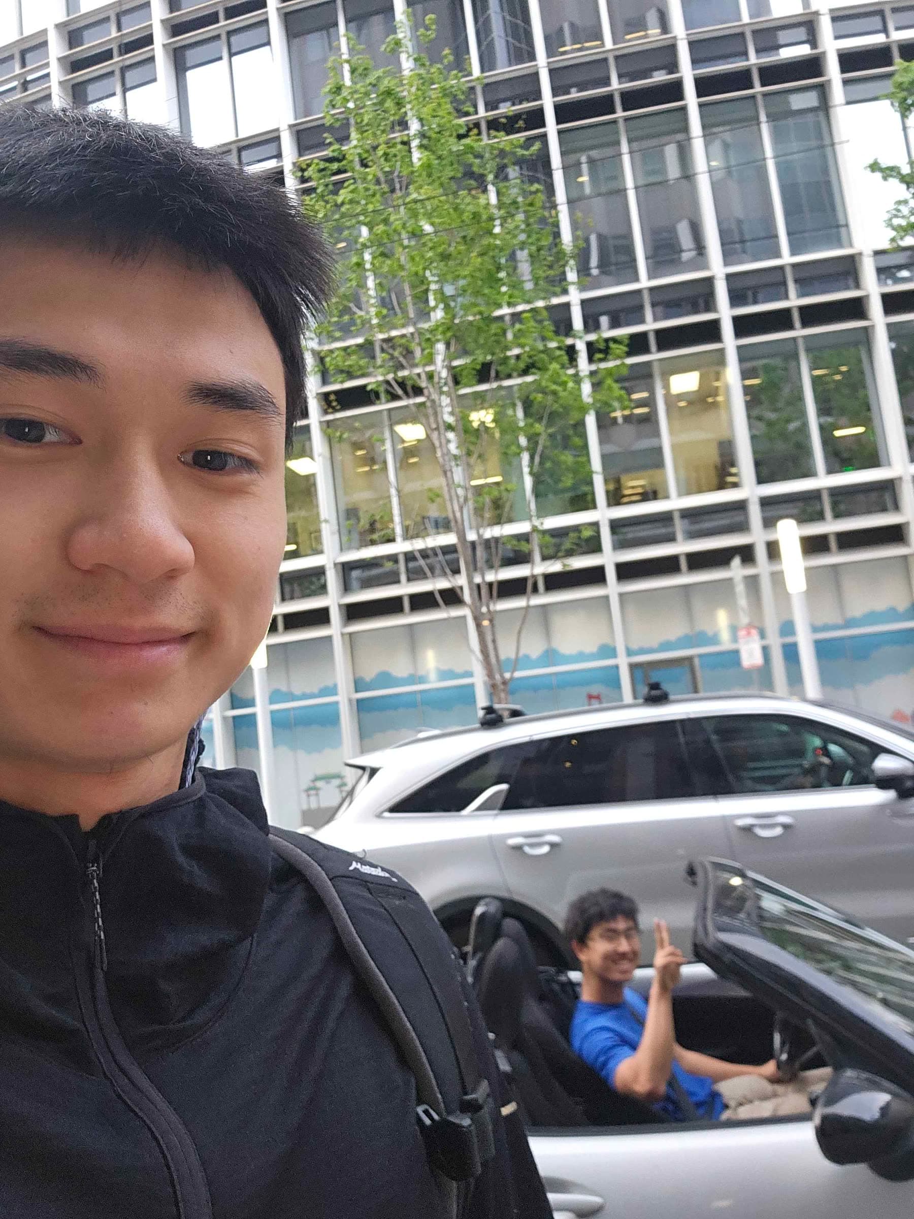One person taking a selfie outside a city building
